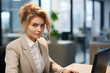 © vefimov - Woman sitting at desk using laptop computer. Suitable for business, remote work, technology, and online communication concepts.