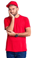 Sticker - Young handsome blond man wearing t-shirt and cap thinking looking tired and bored with depression problems with crossed arms.