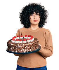 Sticker - Young hispanic couple celebrating birthday with cake relaxed with serious expression on face. simple and natural looking at the camera.