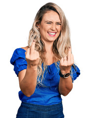 Wall Mural - Young blonde woman wearing casual clothes showing middle finger doing fuck you bad expression, provocation and rude attitude. screaming excited