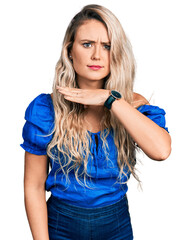 Wall Mural - Young blonde woman wearing casual clothes cutting throat with hand as knife, threaten aggression with furious violence