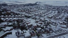 Drone Shot 50fps. Christmas, Above Suburban Houses In English Market Town. Council Estate In Winter, Snow, Cold, Freezing Weather. House Rooftops In A Suburban Setting.