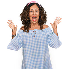 Poster - Middle age hispanic woman wearing casual clothes celebrating victory with happy smile and winner expression with raised hands