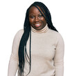 © Krakenimages.com - Young black woman with braids wearing casual winter sweater looking positive and happy standing and smiling with a confident smile showing teeth