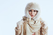© Alliance - happy woman in winter coat and fur hat on white