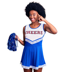 Sticker - Young african american woman wearing cheerleader uniform holding pompom smiling pointing to head with one finger, great idea or thought, good memory