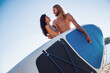 © georgerudy - Couple standup paddleboarding