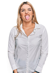 Young caucasian woman wearing casual clothes sticking tongue out happy with funny expression. emotion concept.