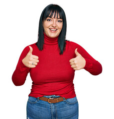 Sticker - Young hispanic woman wearing casual clothes success sign doing positive gesture with hand, thumbs up smiling and happy. cheerful expression and winner gesture.