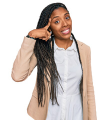 Wall Mural - African american woman wearing business jacket smiling pointing to head with one finger, great idea or thought, good memory