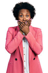 Poster - African american woman with afro hair wearing business jacket shocked covering mouth with hands for mistake. secret concept.