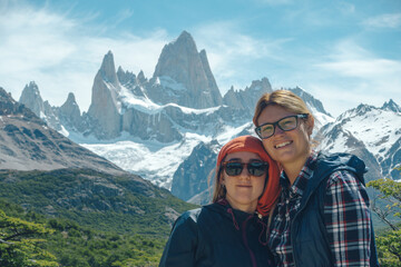 Wall Mural - two girls posing, fitroy mountain in the back