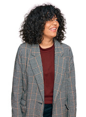 Poster - Young hispanic woman wearing business clothes looking away to side with smile on face, natural expression. laughing confident.