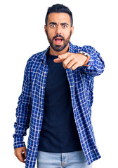 Canvas Print - Young hispanic man wearing casual clothes pointing displeased and frustrated to the camera, angry and furious with you