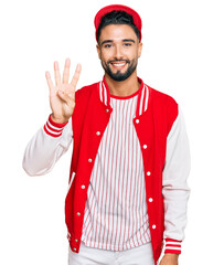 Sticker - Young man with beard wearing baseball uniform showing and pointing up with fingers number four while smiling confident and happy.