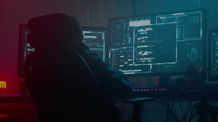 Asian coder focused on cyber attack at dark room with pc