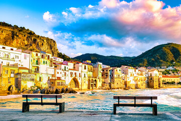 Wall Mural - sunset at the beach of Cefalu Sicily an old town of Cefalu Sicilia panoramic view of the colorful village Italy, two branch at waterfront of the coast in Sicily