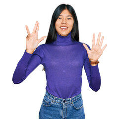 Sticker - Beautiful young asian woman wearing casual clothes showing and pointing up with fingers number nine while smiling confident and happy.