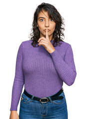 Wall Mural - Young hispanic woman wearing casual clothes asking to be quiet with finger on lips. silence and secret concept.