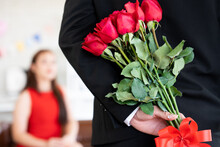 Asian Gentle Boyfriend Hiding Diamond Ring And Red Roses Bouquet Behind Back Prepare For Surprise Pretty Girlfriend With Engagement Wedding In Valentines Day