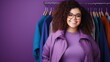 Cheerful chubby woman enjoying shopping looking at camera on purple color background 