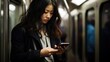 © LELISAT - Candid morning shot of a woman using her smartphone during her subway commute, engrossed in work and connectivity