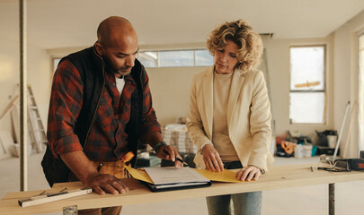 Professional contractor and homeowner signing an agreement for renovation project