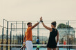 © Jacob Lund - Victorious athletes celebrating championship win in a padel court
