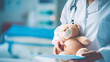 a close-up shot of a doctor holding a teddy bear, symbolizing innocence and vulnerability