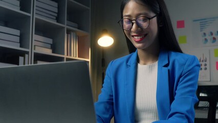 Poster - Asian young beautiful joyful woman smiling while working with laptop in office