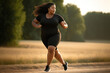 Overweight woman running on summer meadow to reduce weight.