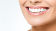 © BlazingDesigns - Partial portrait of a girl with white teeth smiling. Closeup of young woman at dentist's studio isolated on white background.