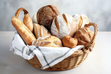 Variety Of Bread In A Basket On Marble Table In Background Of Restaurant Or Bakery. Breakfast Concept Of Light Food And Habit.