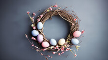 Top View Of Spring Easter Composition With Pastel Easter Eggs Laying On A Wicker Wreath On A Light Blue Background