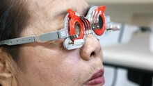 Woman With Some Age Fitted Eye Test Glasses Carefully To Know Her Vision Problem, Bangkok, Thailand.