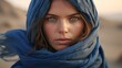 AI generated illustration of a female in a windy desert, her blue scarf billowing in the breeze
