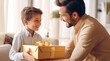 Happy father's day card. Son congratulating his daddy giving him a present at home. Happy birthday. Happy little boy holds a gift box and looks at father. Family holiday celebration, relationship
