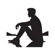 Sitting man silhouette contemplating life's journey with serene calmness. Black vector sitting man silhouette.
