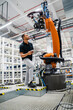 © Westend61 - Technician examining industrial robot in a factory