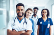© BlazingDesigns - Portrait of multiracial medical team standing in hospital corridor.
