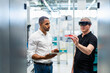 © Westend61 - Technician wearing augmented reality glasses in a factory interacting with colleague