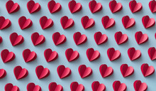 Red Paper Hearts Arranged Over Blue Background