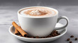 Cup of cappuccino with cinnamon and coffee beans on gray background. 