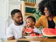 © Lumos sp - child family kitchen food boy son father mother watermelon fruit slice summer organic meal fun preparing healthy diet eating home black