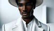 A white suit and hat are worn by an African model
