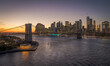 Brooklyn bridge at sunset with Manhattan skyline in the background