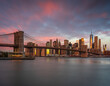 Classic New York skyline with Brooklyn bridge at sunrise with red colour sky