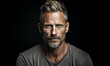 © Bartek - Portrait of a mature man in his 40s with short hair, intense gaze, and confident demeanor against a black studio background in monochrome