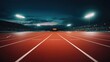 © sambath - An empty outdoor running track at night with the stadium lights shining. From the perspective on the 100 meter dash finish line. Cinematic lighting