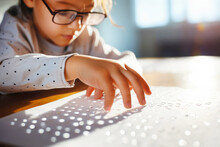 Visually Impaired Girl In In Glasses Reading Braille In The Inclusive Elementary, Primary School. Accessibility And Equality In Classroom. Inclusive Education And World Braille Day Concept. Close Up